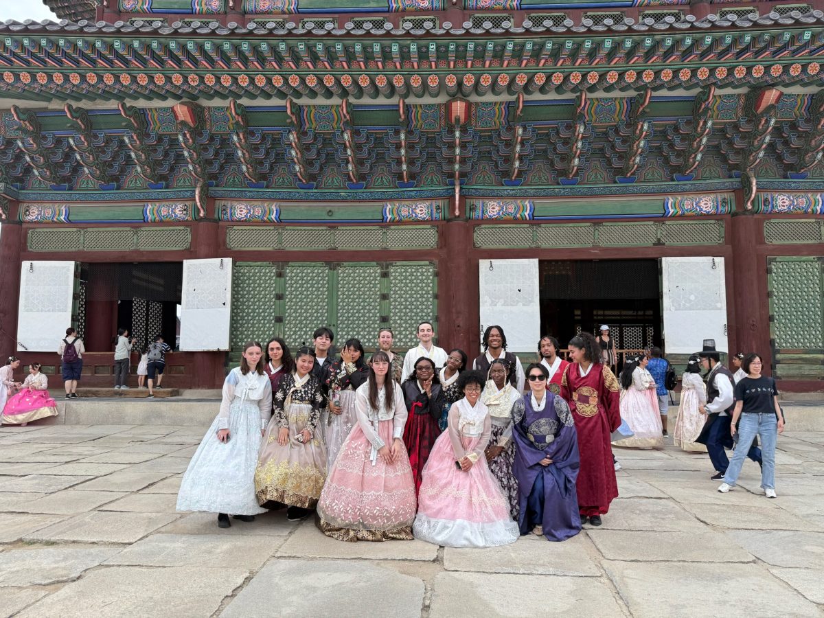 American students in Hanboks, standing a front of the Gyeongbokgung Palace
