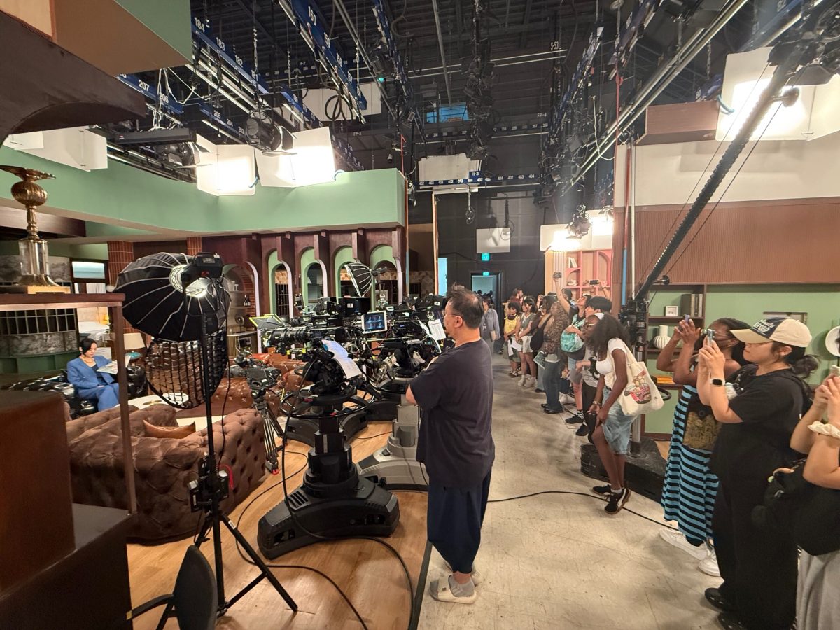 Students watching a camera crew shooting a scene for a K drama