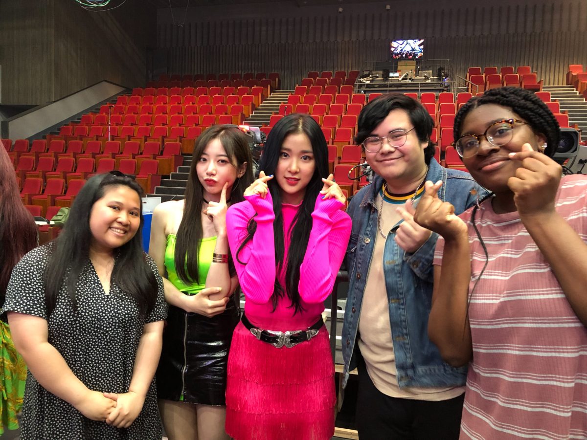 Students posing with 2 kpop idols