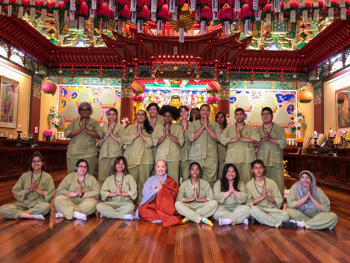 Students with a monk in a temple