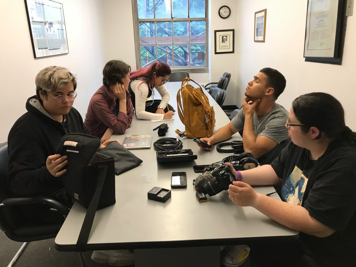 Students learning how to use a camera